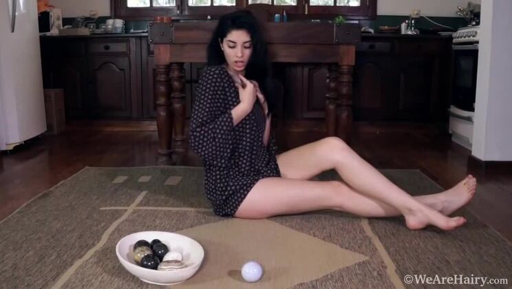 Hairy pussy Ornella rubs stones for solo pleasure